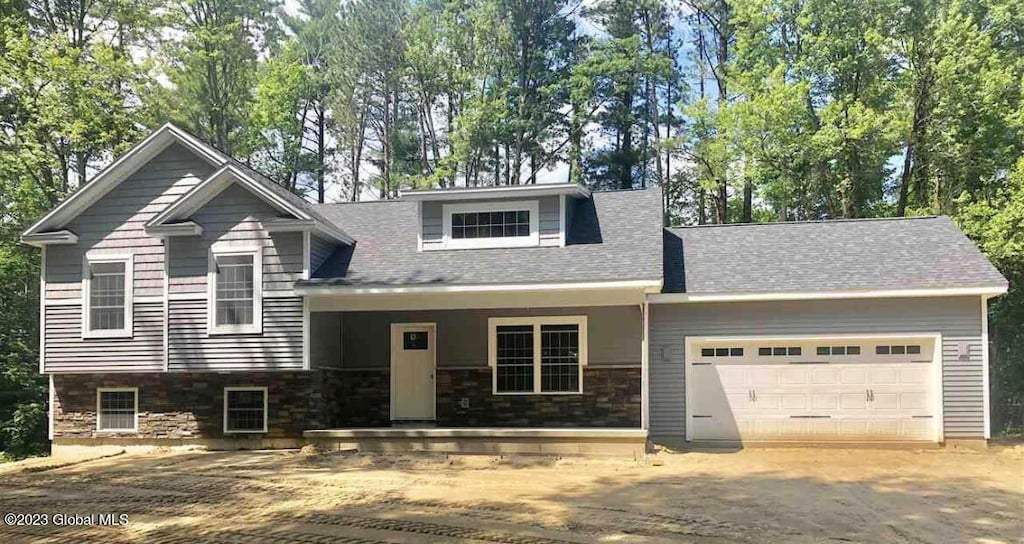 view of front of house with covered porch and a garage