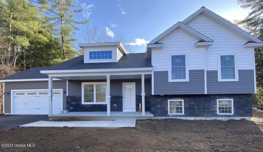 view of front of home featuring a porch and a garage