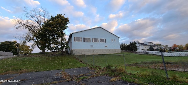 view of side of home with a lawn