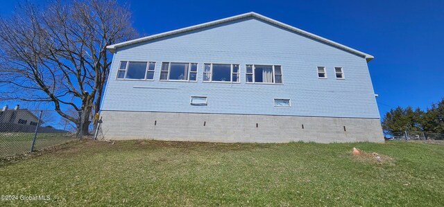 view of side of home with a lawn