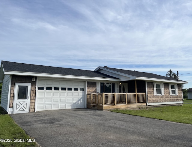 1779 State Highway 67, Johnstown, NY 12095 - ranch-style home featuring a porch, asphalt driveway, and a garage