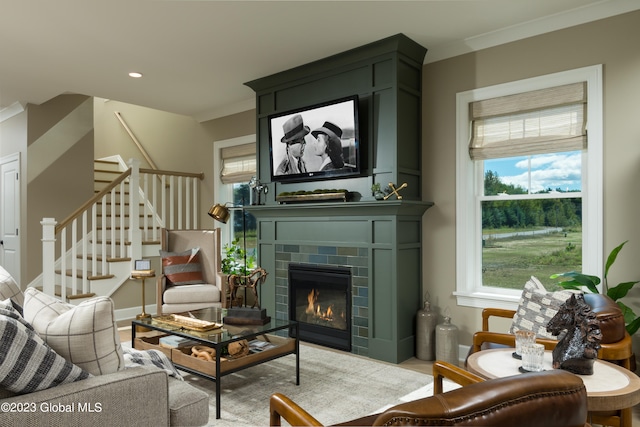 living room featuring ornamental molding and a brick fireplace