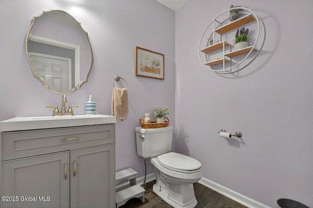33 Sherman Way, Ballston Spa, NY 12020 - half bath featuring wood finished floors, toilet, baseboards, and vanity