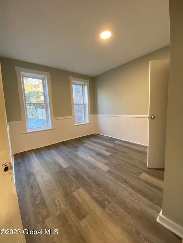 empty room with dark wood-type flooring
