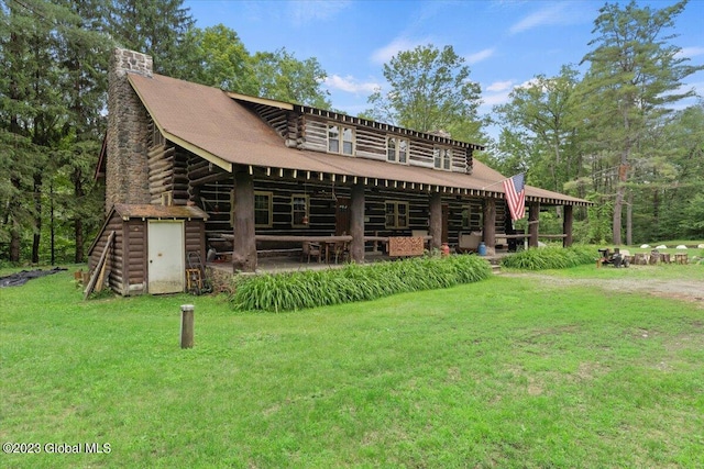 back of property with a lawn