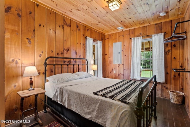 bedroom with dark hardwood / wood-style floors, wooden ceiling, and wood walls