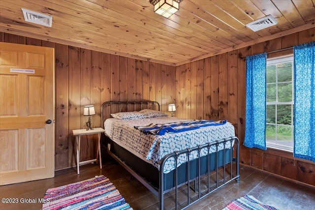 bedroom with wooden walls, multiple windows, and wooden ceiling