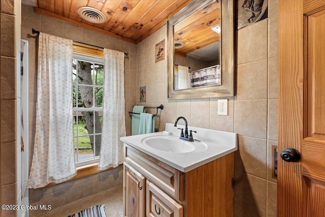 bathroom featuring tile walls, wood ceiling, tile floors, and large vanity