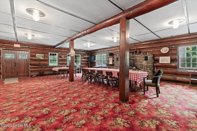 dining space with dark carpet and log walls