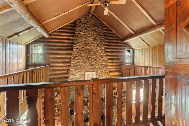 hall with log walls, dark hardwood / wood-style floors, and vaulted ceiling