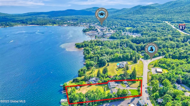 birds eye view of property with a water and mountain view