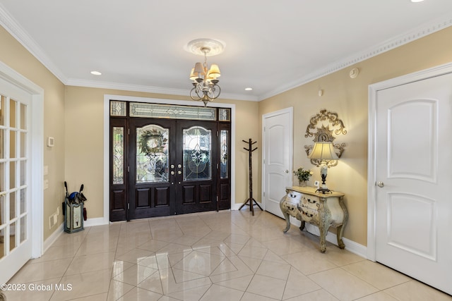 tiled entryway featuring french doors, ornamental molding, and a notable chandelier