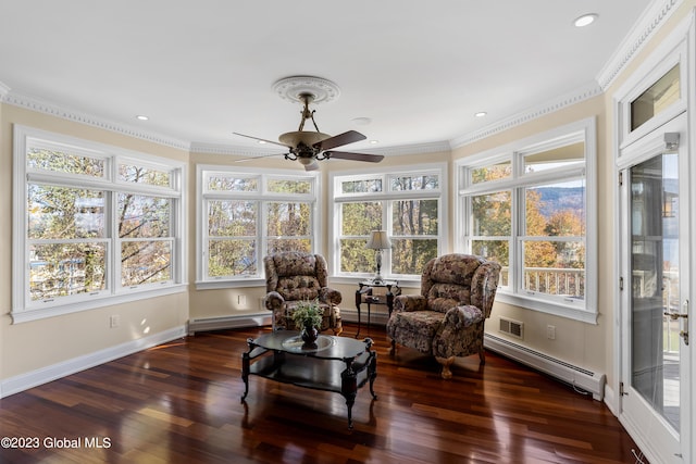 sunroom with ceiling fan, a baseboard radiator, and a healthy amount of sunlight