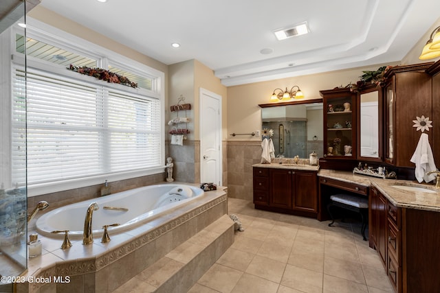 bathroom featuring tiled bath, tile floors, and vanity