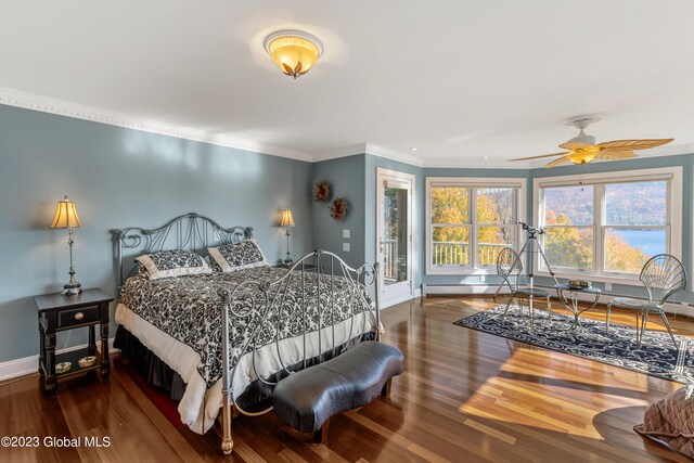 bedroom with dark hardwood / wood-style flooring, ceiling fan, ornamental molding, and access to outside