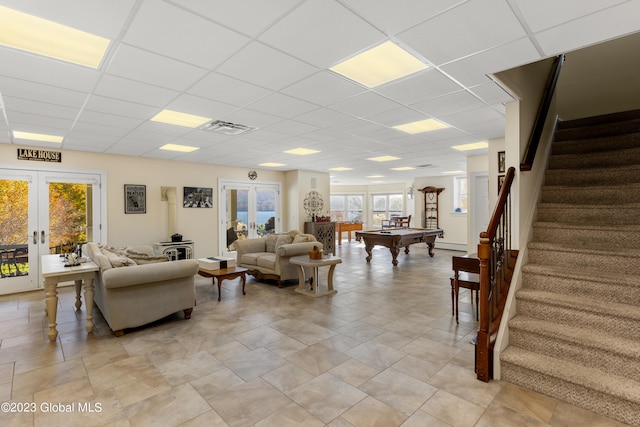 living room featuring french doors, pool table, and a paneled ceiling