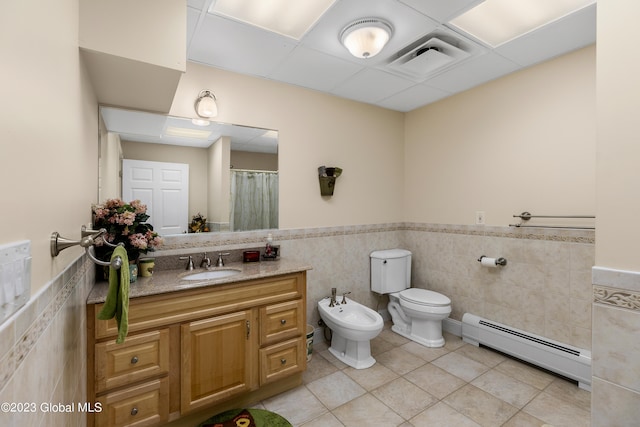 bathroom featuring tile walls, tile floors, toilet, a bidet, and baseboard heating