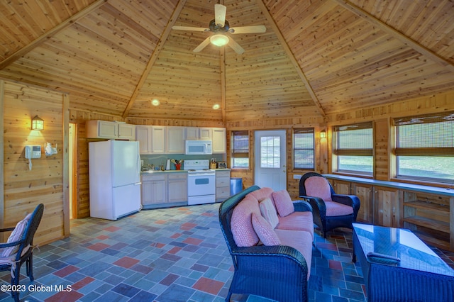 living room featuring wooden walls, ceiling fan, dark tile floors, high vaulted ceiling, and wooden ceiling