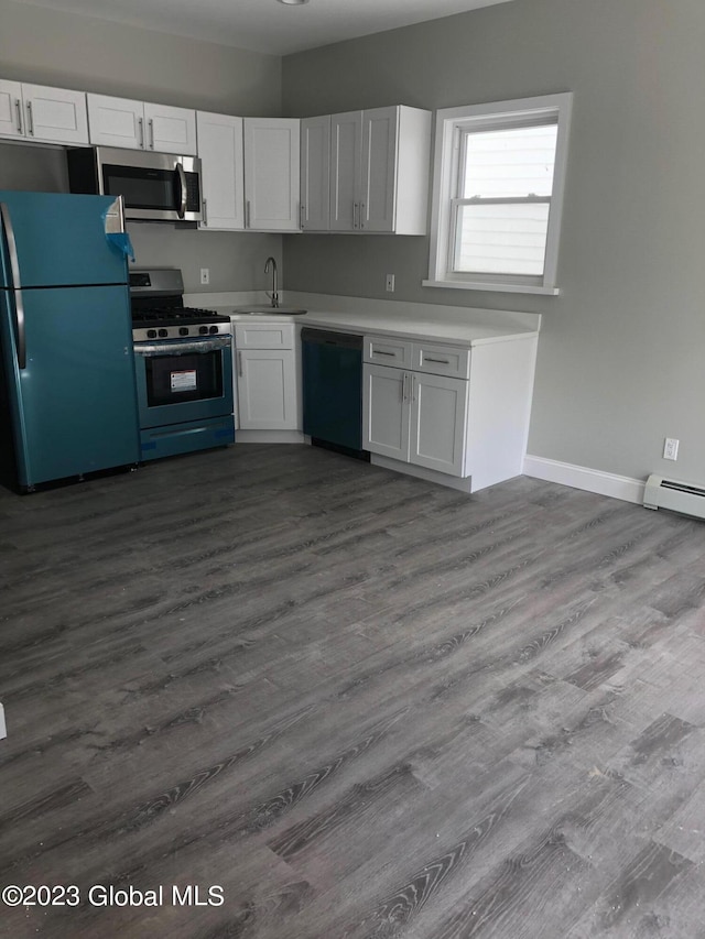 kitchen with appliances with stainless steel finishes, sink, white cabinetry, and dark hardwood / wood-style flooring