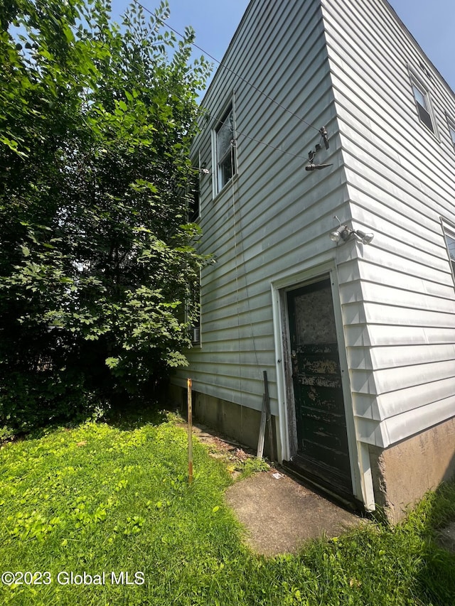 view of side of home with a lawn