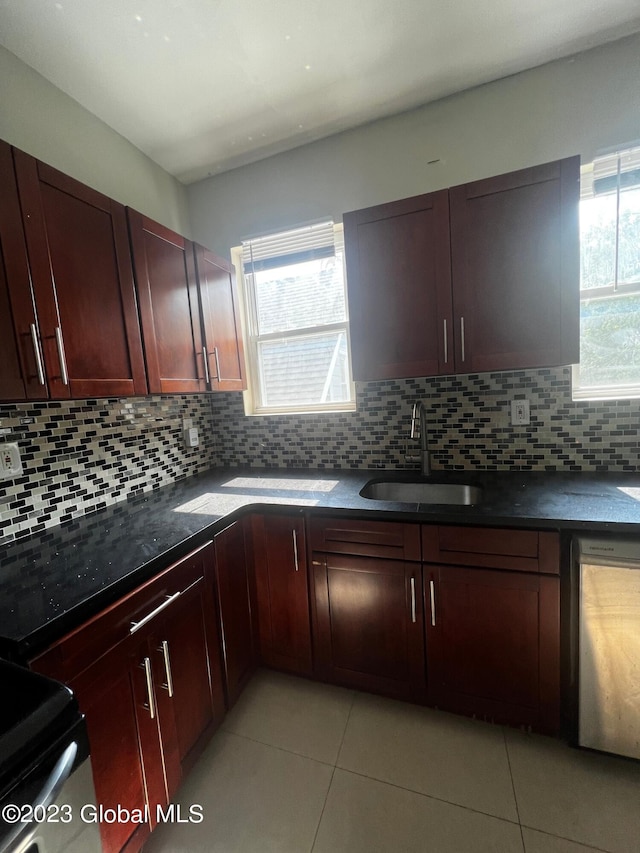 kitchen with stainless steel dishwasher, tasteful backsplash, light tile floors, and sink