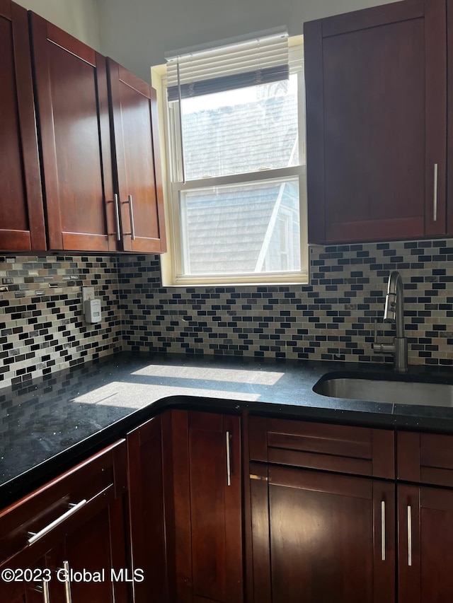 kitchen featuring backsplash and sink