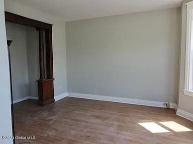 unfurnished room featuring dark hardwood / wood-style floors