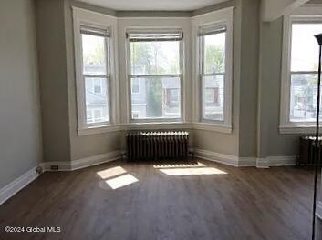 interior space with radiator and dark wood-type flooring