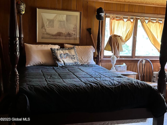 bedroom featuring wood walls