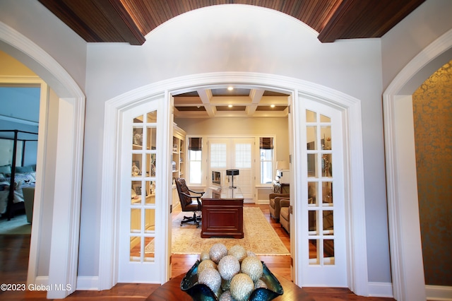 interior space featuring dark hardwood / wood-style flooring, coffered ceiling, and french doors