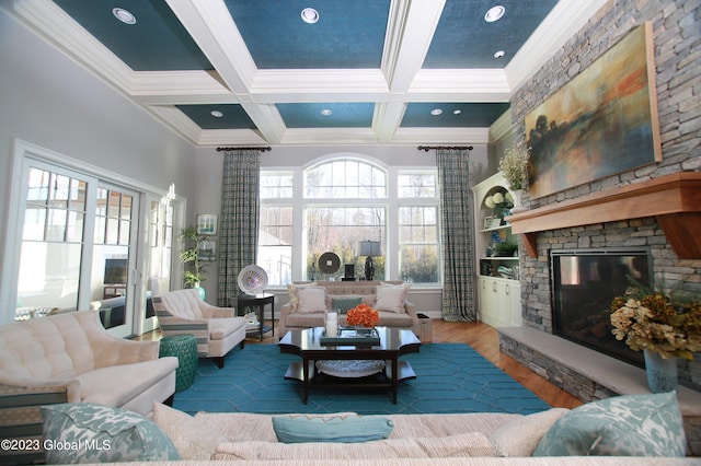 living room with dark hardwood / wood-style flooring, a stone fireplace, beam ceiling, and coffered ceiling