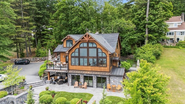 41 Trinity Rock Rd, Lake George, NY 12845 - back of property with a patio, stone siding, a yard, and a standing seam roof