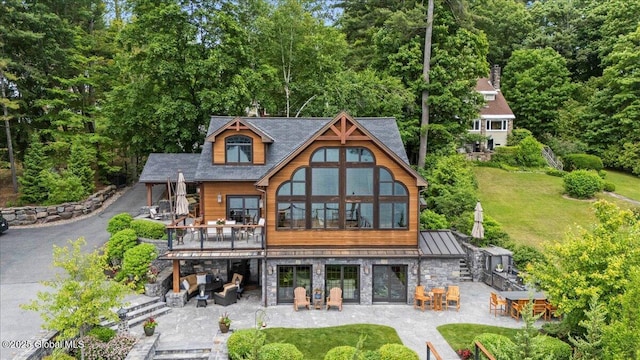 41 Trinity Rock Rd, Lake George, NY 12845 - back of property with a patio, stone siding, a standing seam roof, a lawn, and stairway