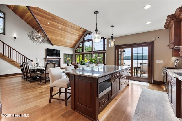 41 Trinity Rock Rd, Lake George, NY 12845 - kitchen with stainless steel microwave, healthy amount of natural light, light wood-style floors, vaulted ceiling, and recessed lighting