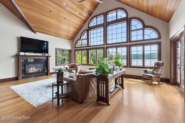 41 Trinity Rock Rd, Lake George, NY 12845 - living area with wood finished floors, wooden ceiling, a tiled fireplace, healthy amount of natural light, and high vaulted ceiling