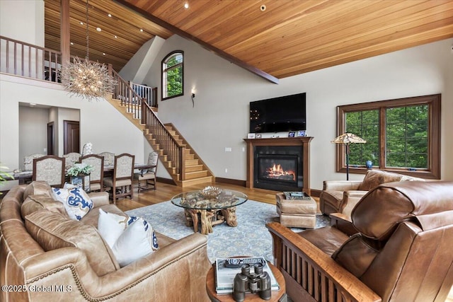 41 Trinity Rock Rd, Lake George, NY 12845 - living room featuring wood ceiling, stairway, wood finished floors, a glass covered fireplace, and a chandelier