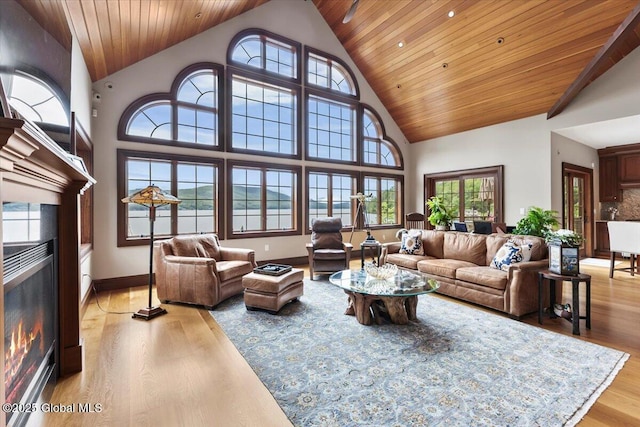 41 Trinity Rock Rd, Lake George, NY 12845 - living room with a glass covered fireplace, light wood finished floors, wood ceiling, healthy amount of natural light, and high vaulted ceiling