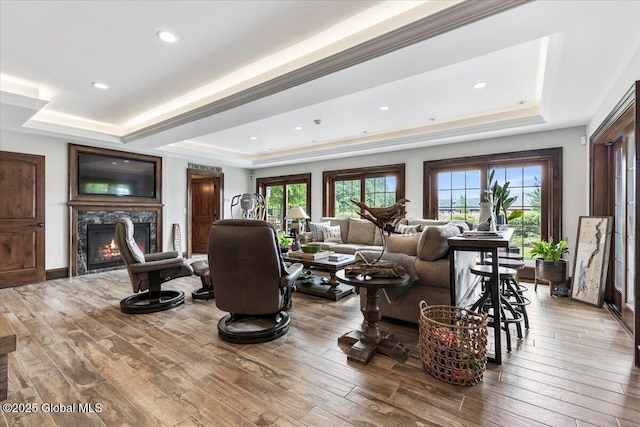 41 Trinity Rock Rd, Lake George, NY 12845 - living area featuring a raised ceiling, a glass covered fireplace, wood-type flooring, recessed lighting, and crown molding