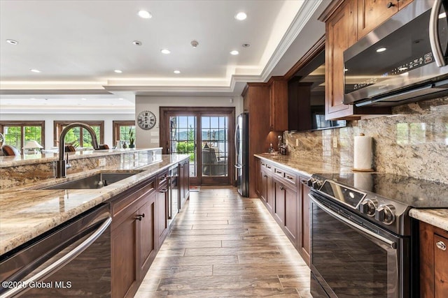 41 Trinity Rock Rd, Lake George, NY 12845 - kitchen featuring appliances with stainless steel finishes, recessed lighting, backsplash, light stone counters, and light wood finished floors