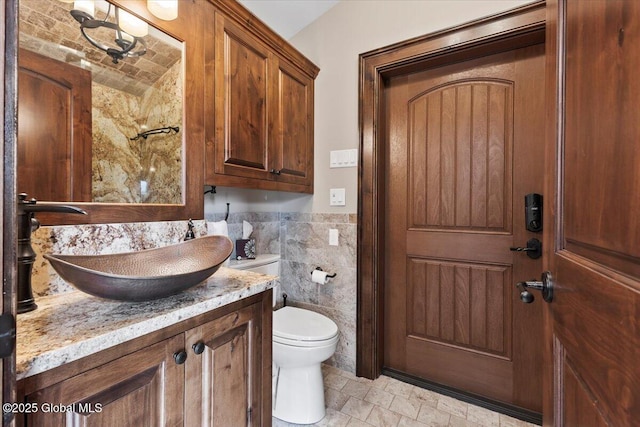 41 Trinity Rock Rd, Lake George, NY 12845 - bathroom featuring vanity, tile walls, stone tile flooring, and wainscoting