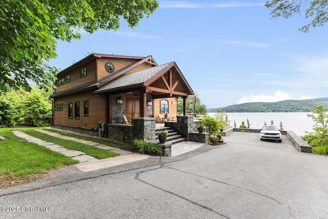 41 Trinity Rock Rd, Lake George, NY 12845 - view of front of property featuring a water view, stone siding, and covered porch