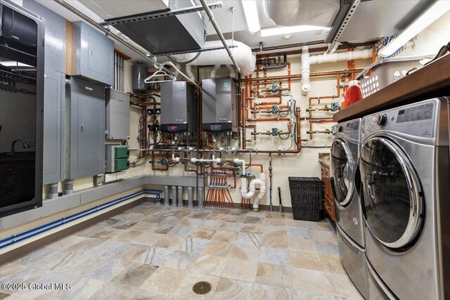 41 Trinity Rock Rd, Lake George, NY 12845 - laundry area with washing machine and clothes dryer, tankless water heater, water heater, electric panel, and stone finish floors