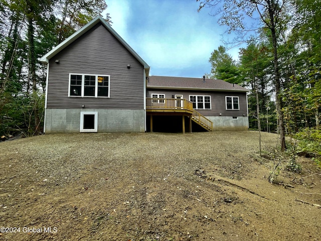 back of property featuring a wooden deck