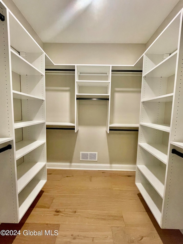 walk in closet featuring hardwood / wood-style flooring