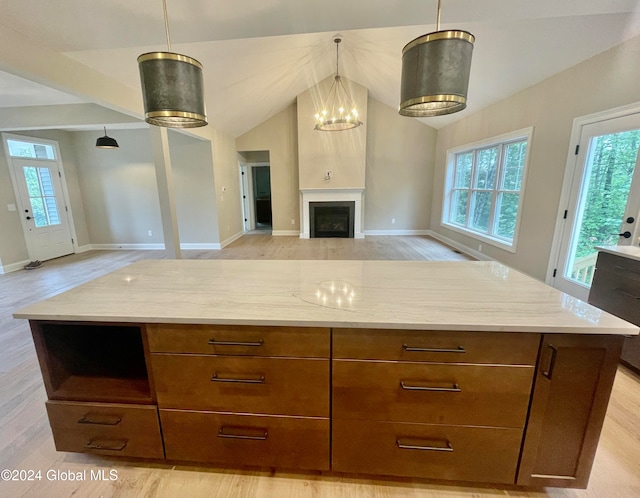 kitchen featuring hanging light fixtures, light hardwood / wood-style flooring, plenty of natural light, and a kitchen island