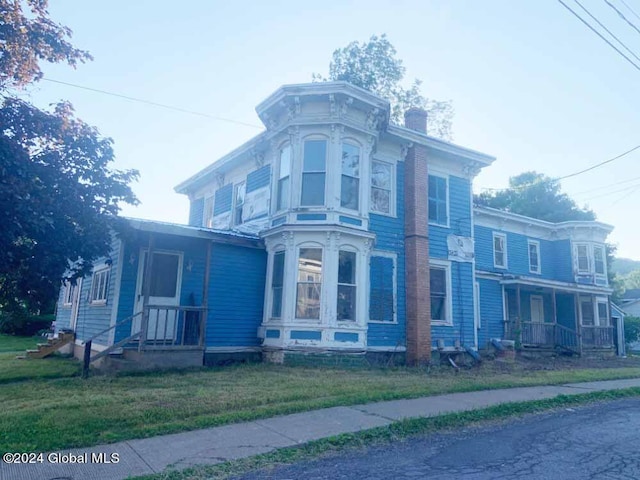 view of side of home with a lawn