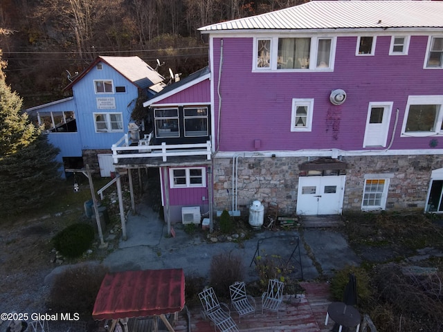 82 N Williams St, Whitehall, NY 12887 - back of house with metal roof and stone siding
