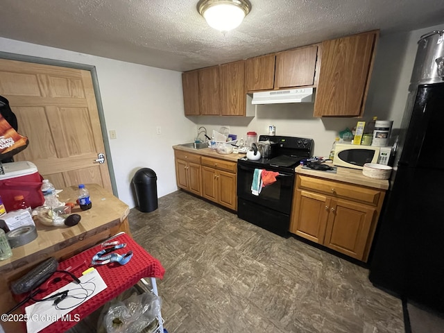82 N Williams St, Whitehall, NY 12887 - kitchen featuring exhaust hood, a textured ceiling, light countertops, a sink, and black appliances