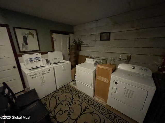 82 N Williams St, Whitehall, NY 12887 - community laundry room featuring wood walls and independent washer and dryer