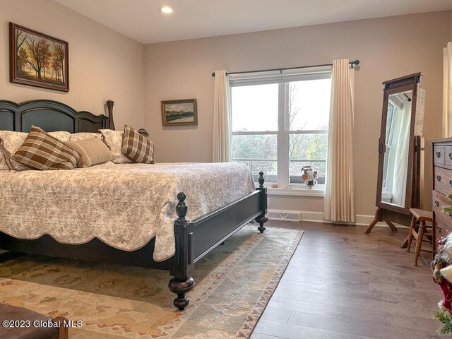 bedroom with dark hardwood / wood-style flooring